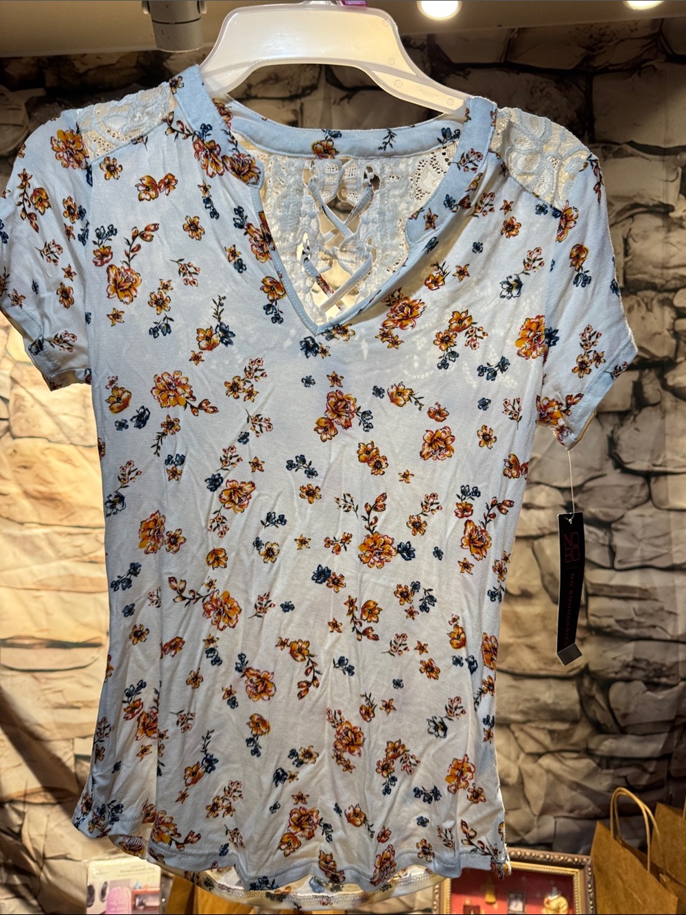 No Boundaries Light Blue Floral V-Neck Lace-Up Tee